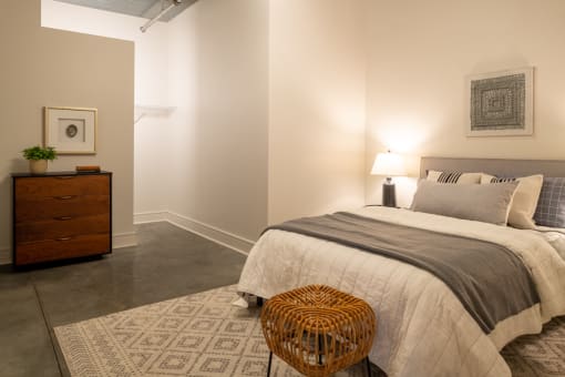a bedroom with a bed and a dresser