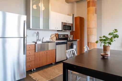 a kitchen with white cabinets and stainless steel appliances