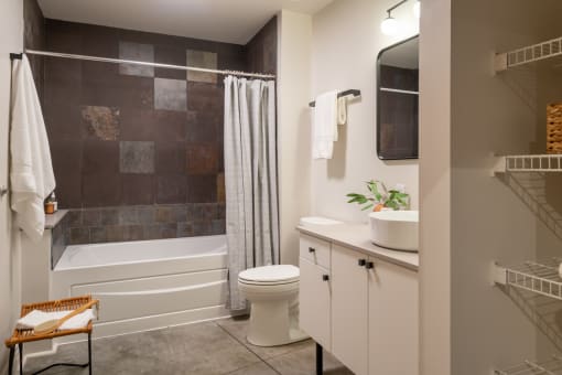 a bathroom with a toilet sink and bathtub in a 555 waverly unit