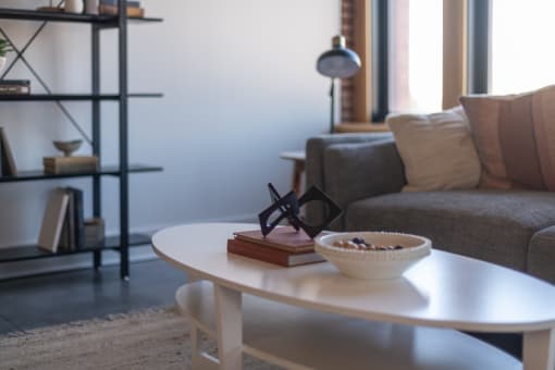 a coffee table with a book and a bowl on it