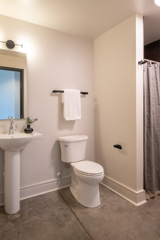 a bathroom with a toilet sink and shower