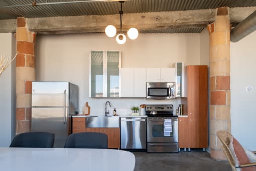 a kitchen with white cabinets and stainless steel appliances