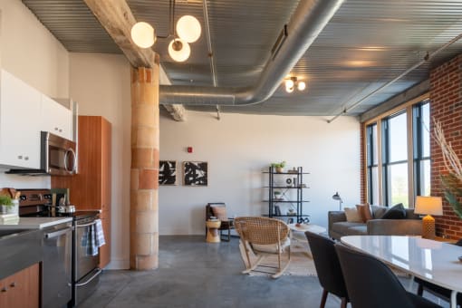 a living room with a kitchen and dining area