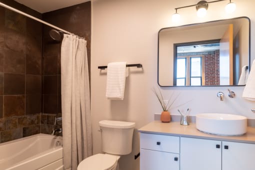 a bathroom with a sink toilet and bathtub