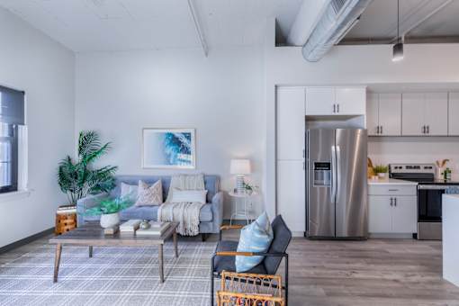 A modern living room with a grey couch and a coffee table.