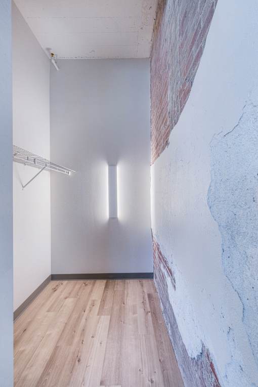A room with a white wall and a wooden floor.