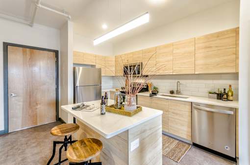 A modern kitchen with wooden cabinets and stainless steel appliances.