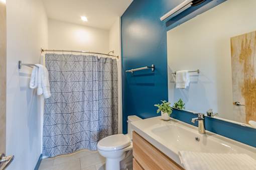 A bathroom with a blue wall and a white toilet.