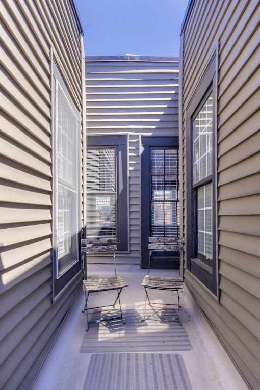A balcony with a chair and a table is shown.
