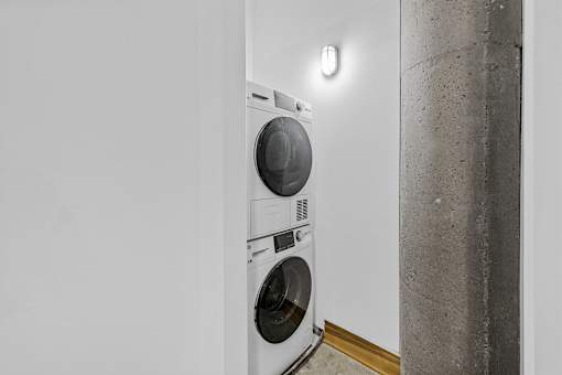 A white washing machine in a laundry room.