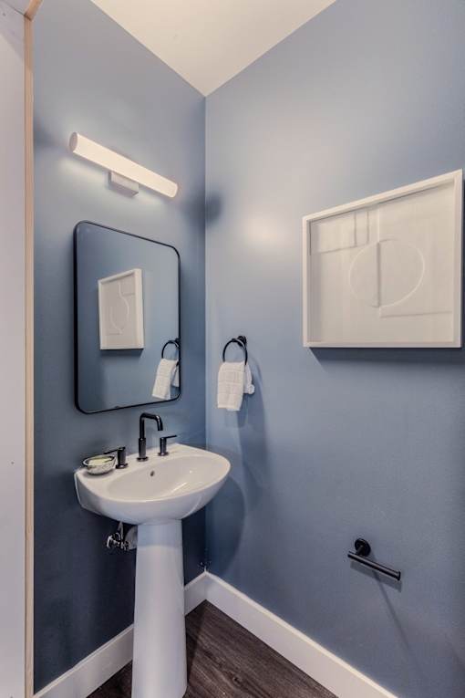 A bathroom with a sink and a mirror.
