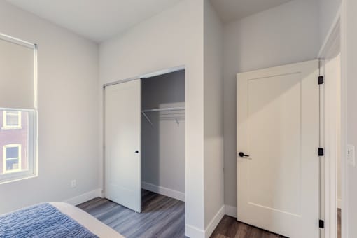 A bedroom with a bed and a closet.