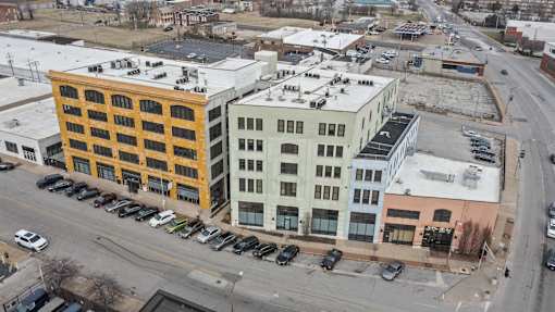 A parking lot is in front of a yellow building.