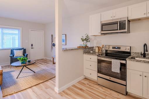 A kitchen with a stove top oven and a microwave above it.