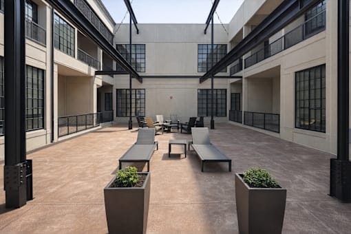 A courtyard with benches and planters.