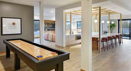A room with a pool table and a framed picture on the wall.