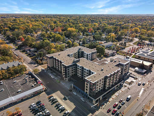 A large building with a parking lot in front of it.