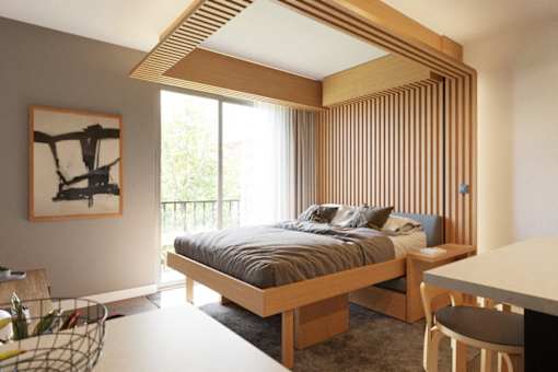 A bedroom with a bed, desk, and chair.
