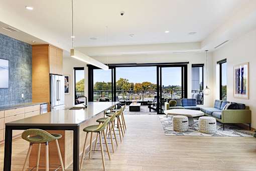 A modern kitchen with a long table and chairs.
