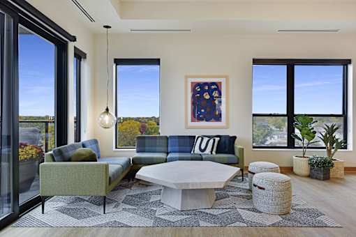 A modern living room with a large window and a view of the outdoors.