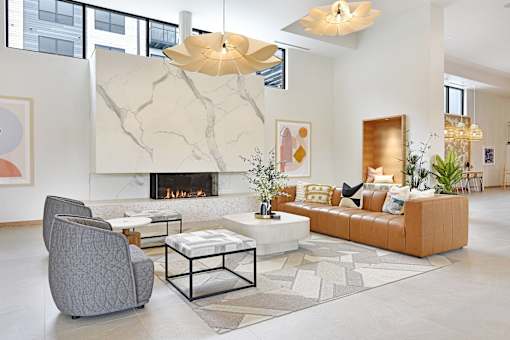 A modern living room with a fireplace and a grey armchair.