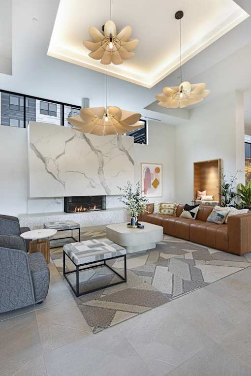 A modern living room with a fireplace and a grey sofa.