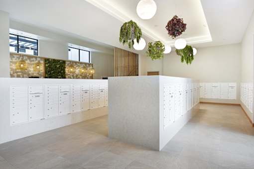 A white reception desk with a white wall behind it.