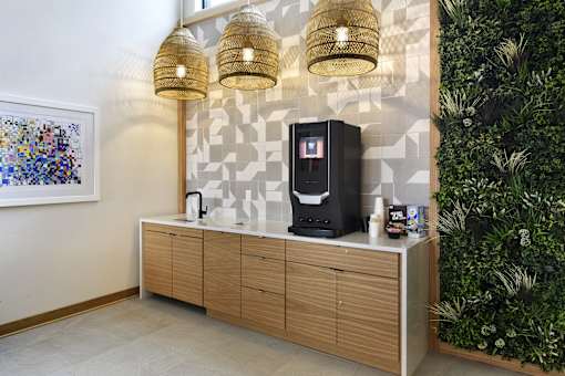 A wall-mounted cabinet with a coffee maker on top.