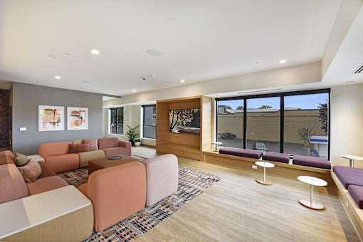 A modern living room with a large window and a wooden floor.
