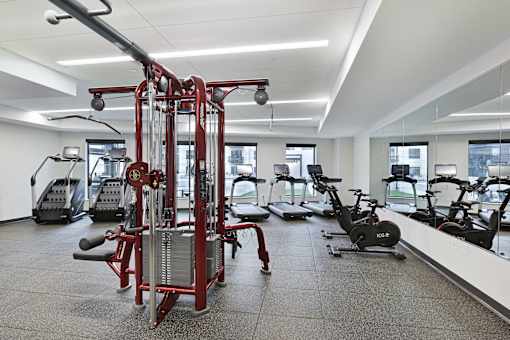 A gym with a variety of equipment including a leg press machine.