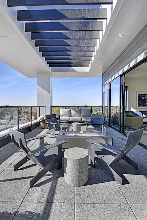 A modern outdoor seating area with a table and chairs.