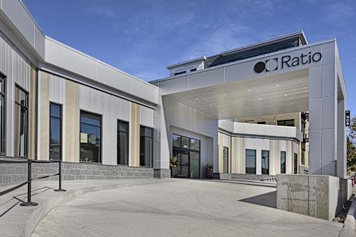 The image shows a modern building with the name "CRatio" on it.