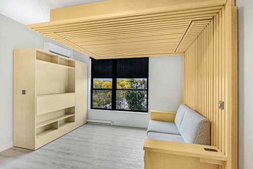 A room with a window and a couch.