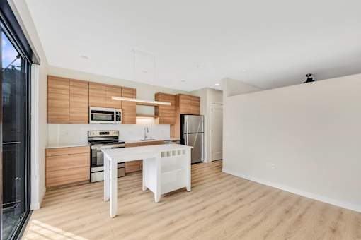 A modern kitchen with wooden accents and white appliances.
