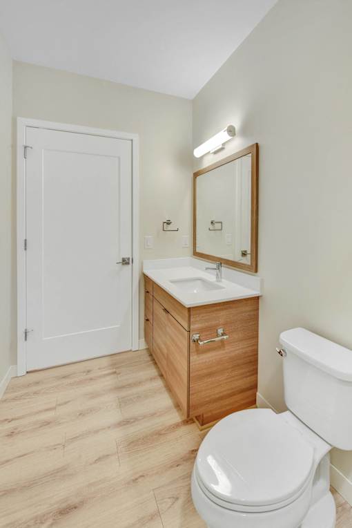 A white toilet sits next to a sink in a bathroom.