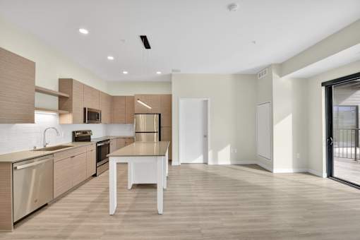 A modern kitchen with a dining table and chairs.