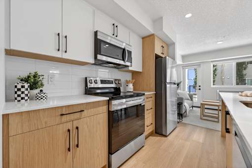 A modern kitchen with wooden cabinets and stainless steel appliances.