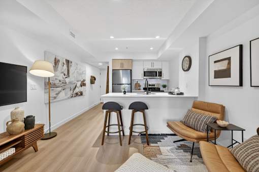 A modern living room with a bar area and a television.