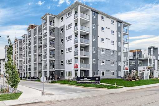 A modern apartment building with a red sign that says 1000.