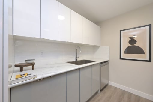 a kitchen with white cabinets and a sink