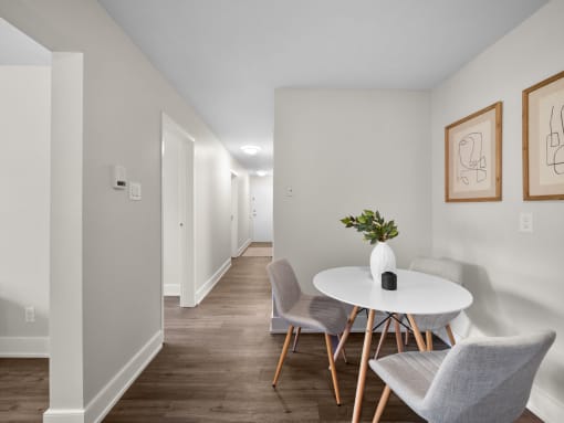 a dining area with a round table and three chairs