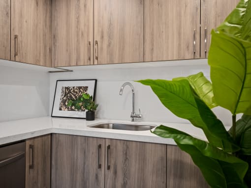 a kitchen with white countertops and wood cabinets
