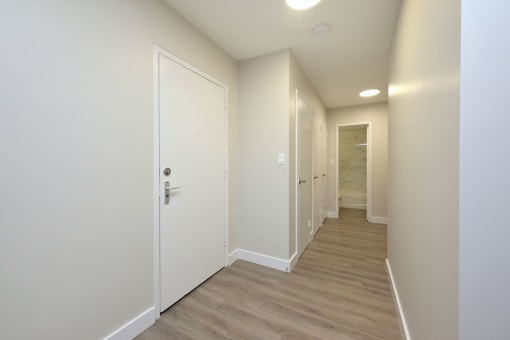 a bedroom with a medium sized bed and a doorway leading to a bathroom