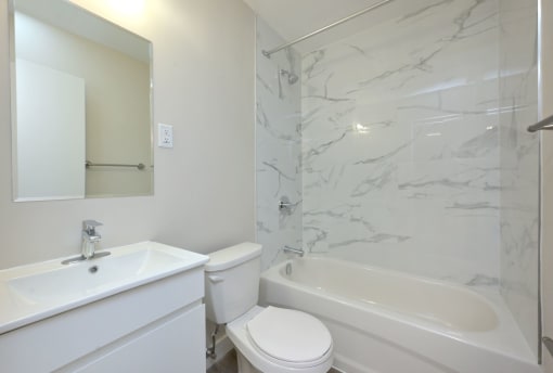 a bathroom with a sink toilet and bathtub