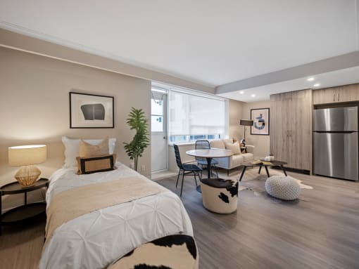 a bedroom with a bed and a couch in a 555 waverly unit