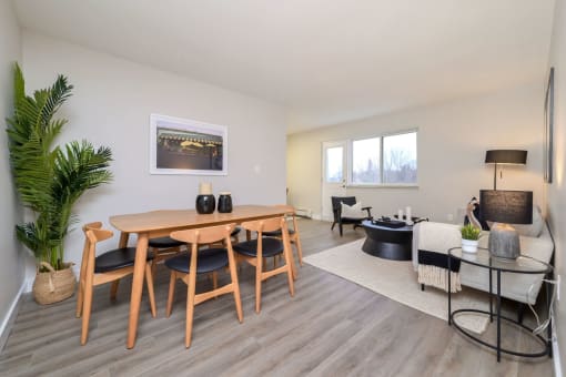 a dining area with a wooden table and chairs and a living room with a couch and a