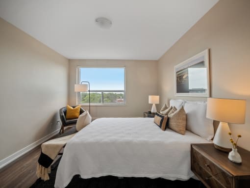 a bedroom with a large bed and a window