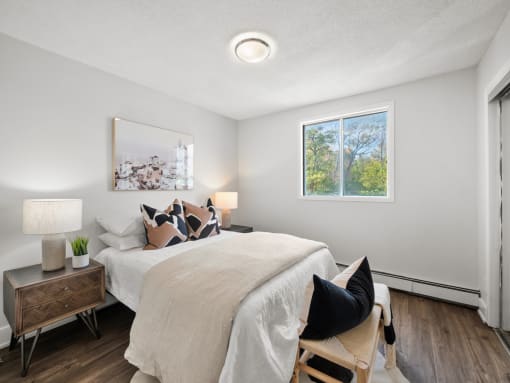 a bedroom with a large bed and a window