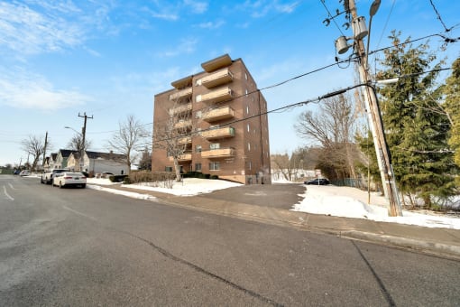 a brick apartment building on a snowy street