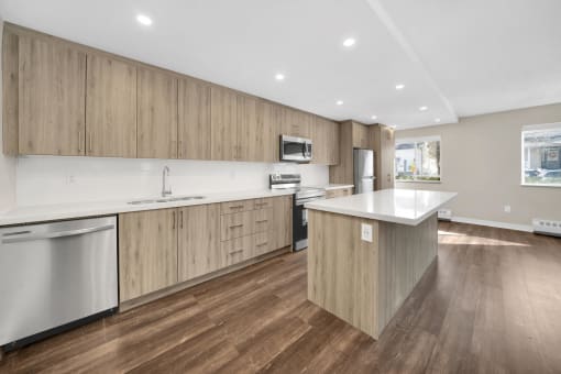 a kitchen with white countertops and wooden cabinets